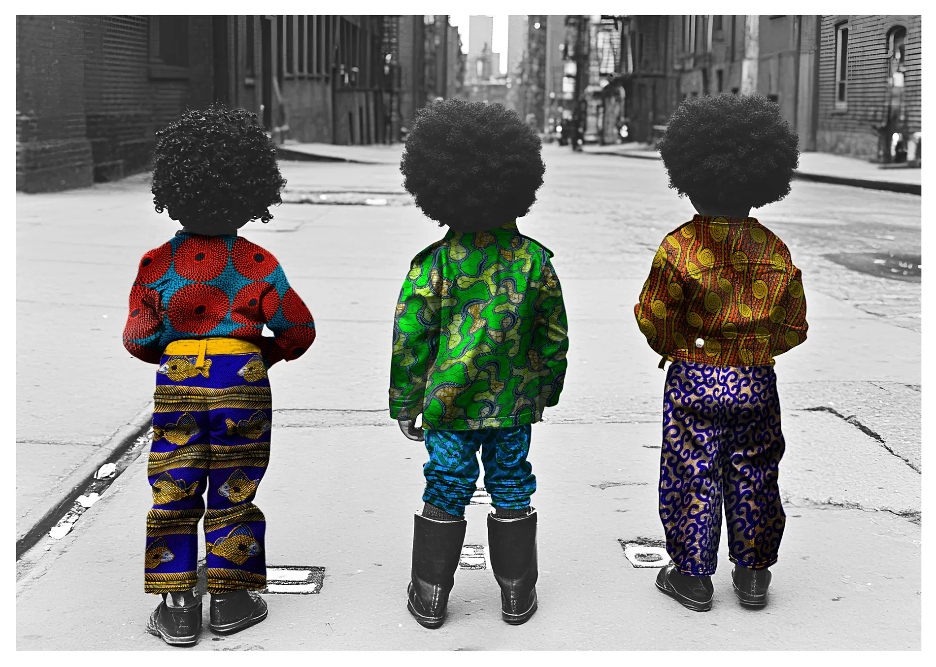 Three boys seen from behind on a black-and-white city street, each wearing vividly patterned clothes.