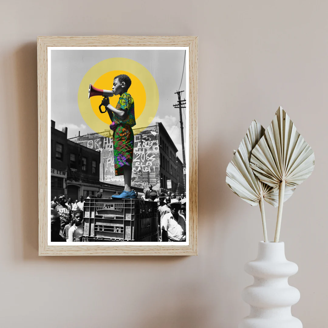 The Frequency of Love megaphone artwork displayed as wall art in a pale wood frame beside sculptural dried leaves.